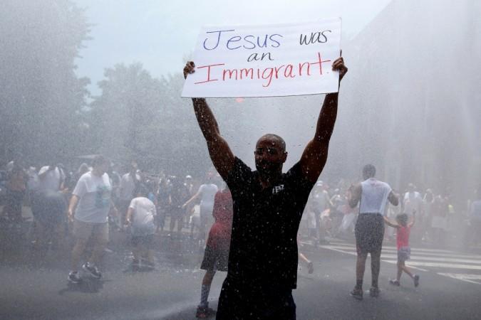 A demonstrator holds up a placard during a national day of action called Deonstrator hold up a placard at the anti-Trump protest in Los Angeles