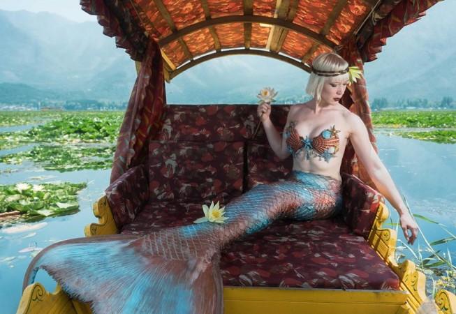 An American tourist, Iara Mandyn poses as a mermaid in Kashmir's Dal lake Iara Mandyn