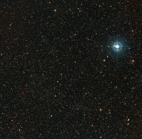 This colourful image shows the sky around the faint orange dwarf star PDS 70 (in the middle of the image). The bright blue star to the right is χ Centauri Star PDS70