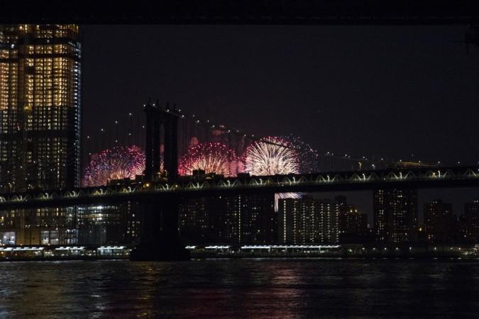 Fireworks are seen from the East River on the South Brooklyn route of a New York City ferry on July 4, 2017 US Independence Day 2017