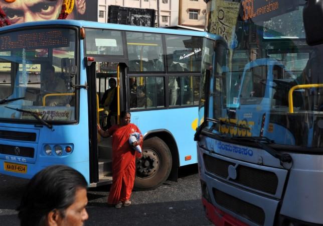 Indian commuters wait to board a bus in Bangalore Indian commuters wait to board a bus in Bangalore