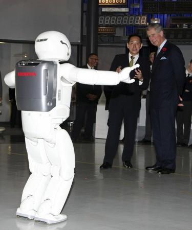 Britain's Prince Charles looks at Honda's humanoid robot, Asimo, at the National Museum Of Emerging Science And Innovation in Tokyo October 28, 2008. Honda's humanoid robot, Asimo, greeting Prince Charles in Tokyo