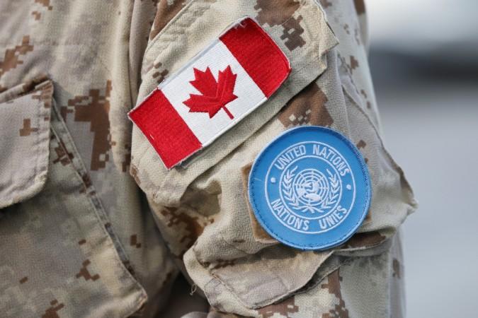 A Canada flag patch and UN patch are seen on a member of Canadian Forces before departing for a United Nations peacekeeping mission in Mali. A Canada flag patch and U.N. patch