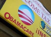 A sign on an insurance store advertises Obamacare in San Ysidro, San Diego, California,