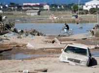 A local resident is seen in a flooded area in Mabi town in Kurashiki, Okayama Prefecture