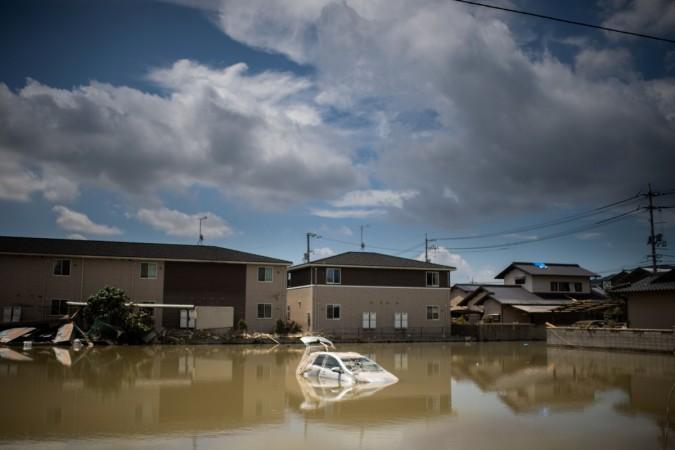 A car sits in water after the area was devastated by flooding and landslides in Mabi, Okayama prefecture Japan floods