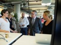 German Interior Minister Thomas de Maiziere talks to employees during a vistit at the Facebook office in Berlin