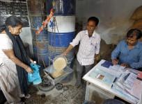 A woman buys wheat from a government-run ration shop