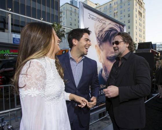 Director of the movie and cast member Russell Crowe (R) greets actor Eli Roth and his wife Lorenza Izzo at the premiere of Eli Roth