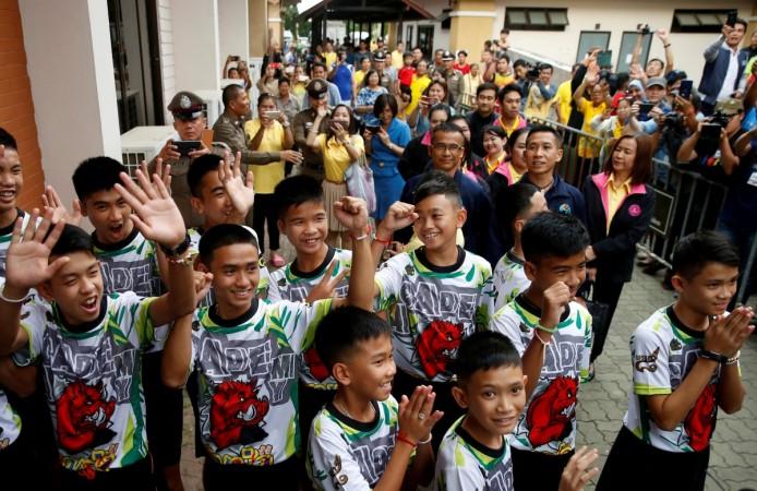People react as the 12 soccer players and their coach who were rescued from a flooded cave arrive for their news conference in the northern province of Chiang Rai, Thailand, July 18, 2018. Thai boys news conference