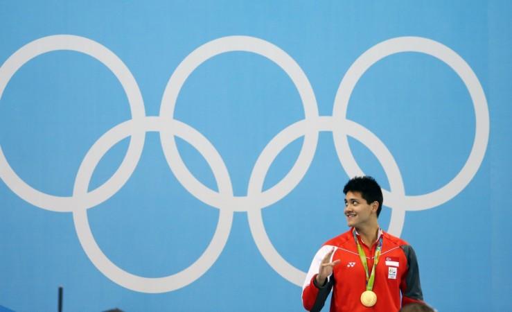 2016 Rio Olympics - Swimming - Victory Ceremony - Men's 100m Butterfly Victory Ceremony - Olympic Aquatics Stadium - Rio de Janeiro, Brazil - 12/08/2016. Joseph Schooling (SIN) of Singapore celebrates on the podium Joseph Schooling (SIN) of Singapore celebrates on the podium