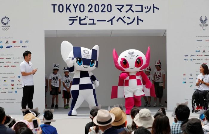 Japan's Olympic swimmer Daiya Seto and Japan's Paralympic canoeist Monika Seryu look on as Tokyo 2020 Olympic Games mascot Miraitowa and Paralympic mascot Someity arrive on stage during the mascots' debut in Tokyo, Japan, July 22, 2018. Tokyo 2020 Olympic Games mascot Miraitowa and Paralympic mascot Someity