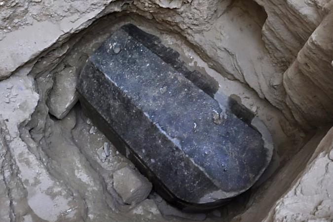 This picture released on July 1, 2018, by the Egyptian Ministry of Antiquities shows an ancient tomb dating back to the Ptolemaic period found in the Sidi Gaber district of Alexandria. - The tomb, which dimensions are a height of 185 cm, length 265 cm and width of 165 cm, contains a black granite sarcophagus considered to be the largest to be discovered in Alexandria Alexandrian sarcophagus