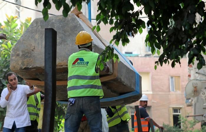 Coffin is moved over by a truck after archaeologists unearthed a sarcophagus containing three mummies Alexandrian sarcophagus