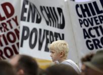 Demonstrators listen to speakers at a rally in Trafalgar Square