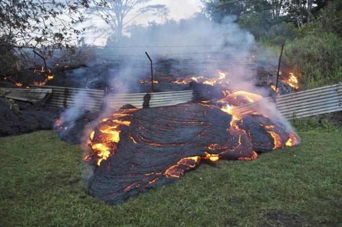 The lava flow from the Kilauea Volcano burns vegetation as it approaches a property boundary in a U.S. Geological Survey (USGS) image taken near the village of Pahoa, Hawaii, October 28, 2014. The lava flow from the Kilauea Volcano