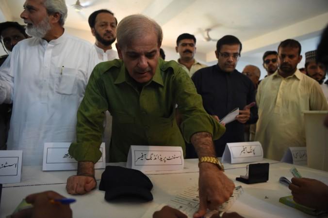 Shabaz Sharif, the younger brother of ousted Pakistani Prime Minister Nawaz Sharif and the head of Pakistan Muslim League-Nawaz (PML-N), prepares to cast his vote during Pakistan's general election at a polling station in Lahore on July 25, 2018. - Polls opened on July 25 in a tense, unpredictable Pakistani election that could be former World Cup cricketer Imran Khan's best shot at power, after a campaign marred by allegations of military interference and a series of deadly attacks. (WAKIL KOHSAR/AFP/Getty Images) pakistan general elections