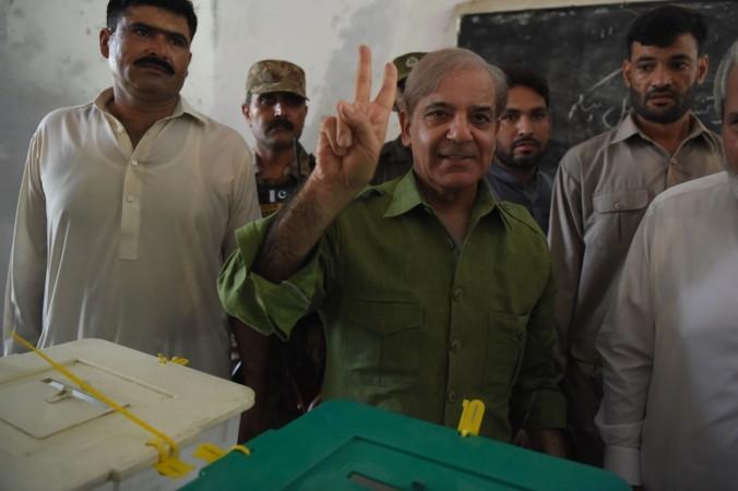 Shabaz Sharif, the younger brother of ousted Pakistani Prime Minister Nawaz Sharif and the head of Pakistan Muslim League-Nawaz (PML-N), casts his vote during Pakistan's general election at a polling station in Lahore on July 25, 2018. - Polls opened on July 25 in a tense, unpredictable Pakistani election that could be former World Cup cricketer Imran Khan's best shot at power, after a campaign marred by allegations of military interference and a series of deadly attacks. pakistan general elections