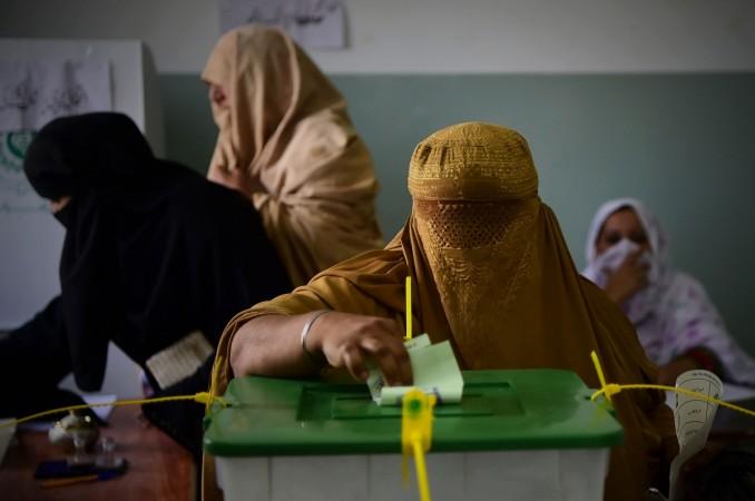 A burqa-clad woman casts her vote during Pakistan's general election. Pak elections