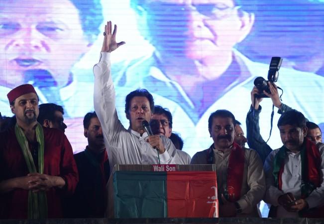 Pakistani cricket star-turned-politician and head of the Pakistan Tehreek-e-Insaf (PTI) Imran Khan (C) gestures as he delivers a speech during a campaign meeting ahead of the general election in Lahore on July 23, 2018. - Pakistan will hold the general election on July 25, 2018. (WAKIL KOHSAR/AFP/Getty Images) pakistan general elections
