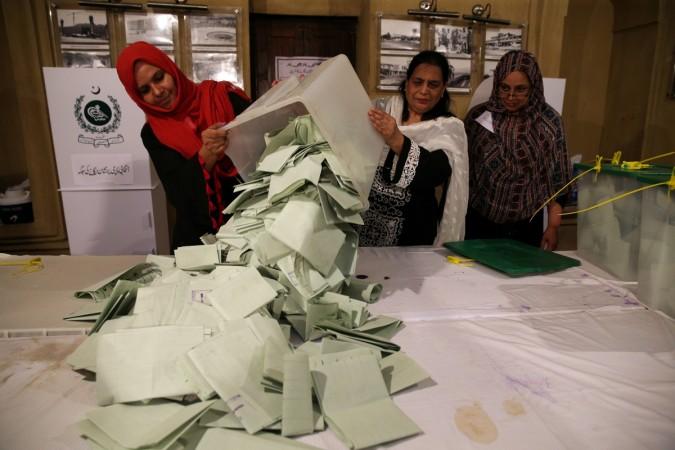 Election officials count ballots after polls closed during the general election in Islamabad, Pakistan, July 25, 2018. 2018 Pakistan elections