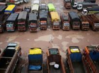 driver walks past parked trucks