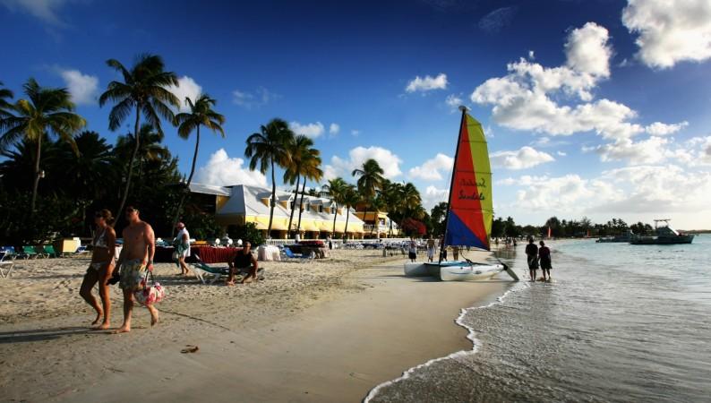 A catamaran with a colourful sail sits on the beach just outside St John's on March 10, 2008 in Dickenson Bay, Antigua. Antigua