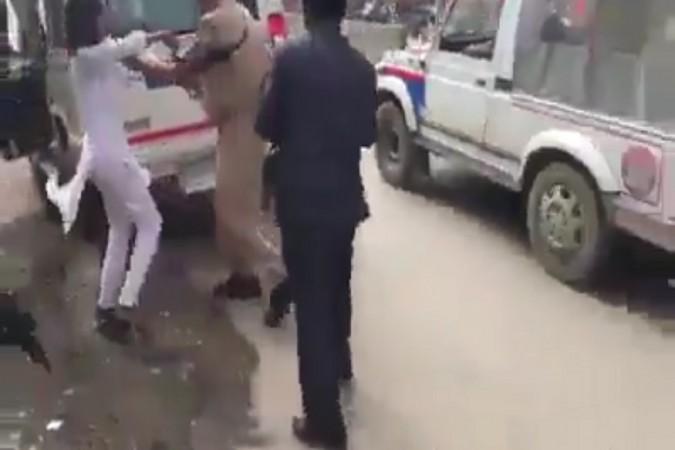 A screenshot from the video that went viral, where male police officers manhandled and roughed up two female protestors. Screenshot of the UP police manhandling two female protestors