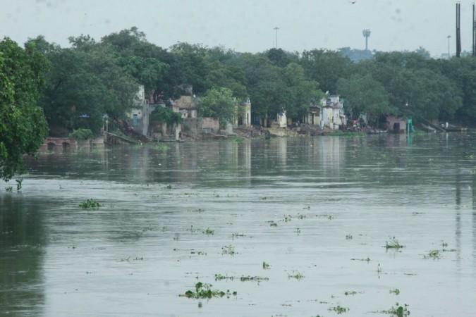 A view of the swollen Yamuna river following incessant rains, in New Delhi, on July 27, 2018. The water level in the Yamuna in Delhi has reached 203.84 metres and is expected to touch the warning mark by Saturday morning. It is now flowing just 16 cm below the danger level of 204.83 metres. Yamuna river flooding