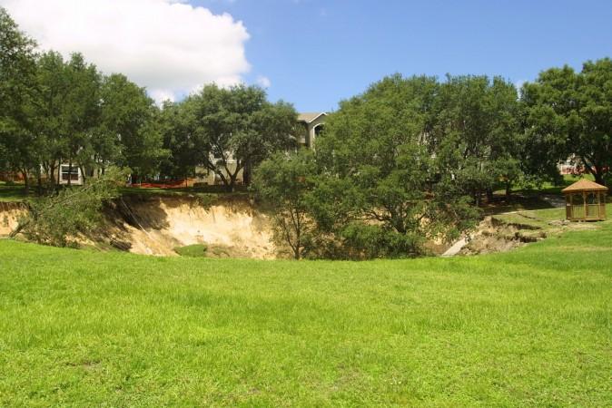 Florida Sinkhole Measures 60 Feet Deep, it swallowed trees, pipelines and a section of sidewalk --Representational image Sinkhole