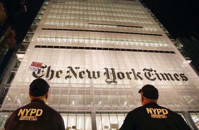 New York Police Department officers watch as they wait for the climber David Malone to descend after hanging a banner on the outside of the New York Times Building in New York on July 9, 2008 New York Times Building