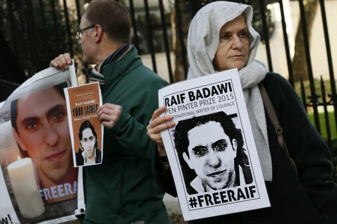 Demonstrators hold placards during a protest for Saudi blogger Raif Badawi, outside the Saudi Arabian Embassy in London, Britain January 8, 2016. Saudi blogger Raif Badawi,