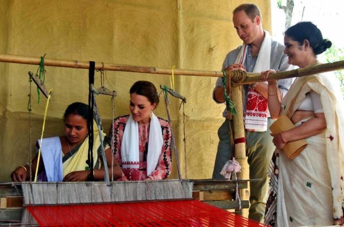 A woman works on a handloom as Catherine, the Duchess of Cambridge, and her husband Britain's Prince William look on in Panbari village in Kaziranga in the northeastern state of Assam, India handloom