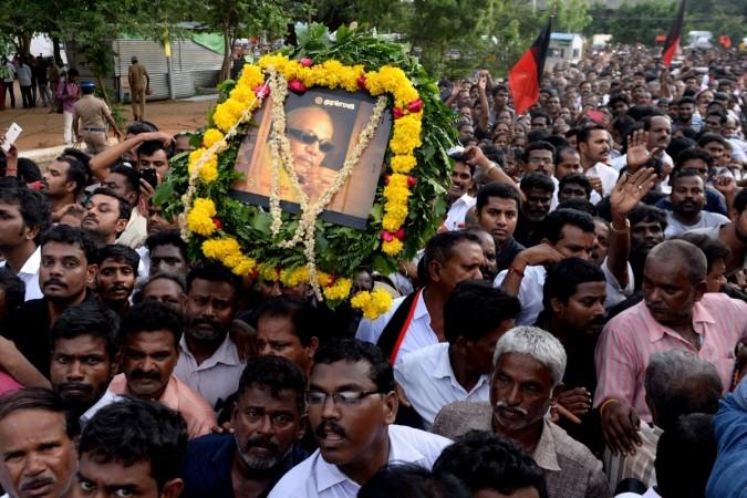 Followers of M Karunanidhi carry his framed picture during the funeral procession in Chennai. (Getty Image by Arun Shankar) Karunanidhi funeral
