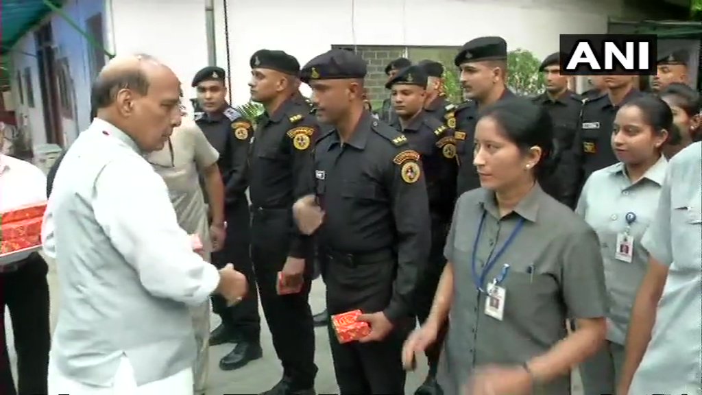 Union Home Minister Rajnath Singh gives sweets to security personnel at his residence on I-Day. independence day