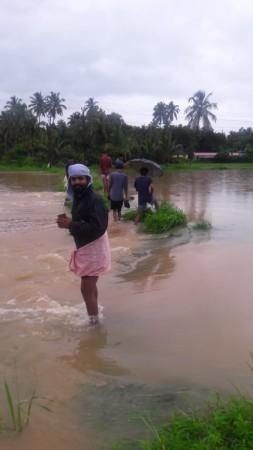 A young guy trying to catch fish from roads Kerala Floods
