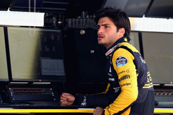 Carlos Sainz of Spain and Renault Sport F1 looks on from the pitwall Carlos Sainz