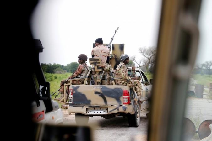 A Nigerian army convoy vehicle drives ahead with an anti-aircraft gun, on its way to Bama, Borno State, Nigeria August 31, 2016. Picture taken from inside a vehicle boko haram