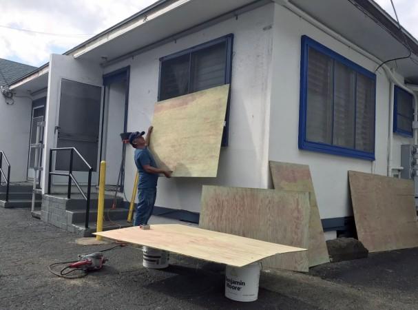 Vicente Rodriguez of Honolulu covers the windows of his house on August 22, 2018, as he prepares for Hurricane Lane to impact Hawaii. Hurricane Lane
