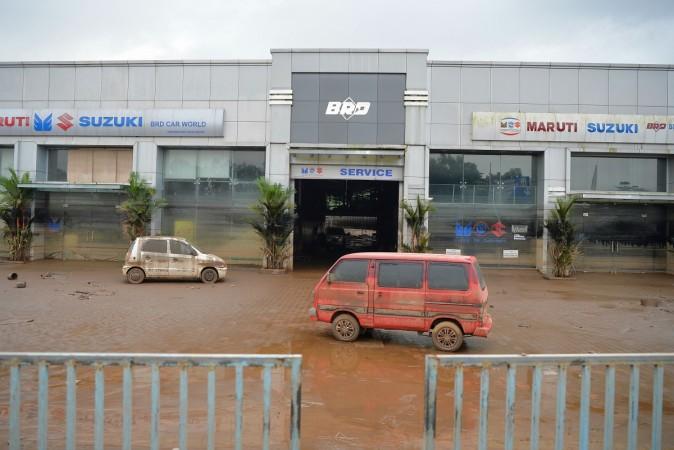 Vehicles lie abandoned at a car showroom and service station after flood waters receded at Chalakudi Taulk in Thrissur District, Kerala floods