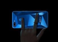 Realme 2 has a dual rear camera with fingerprint scanner on a diamond-cut back