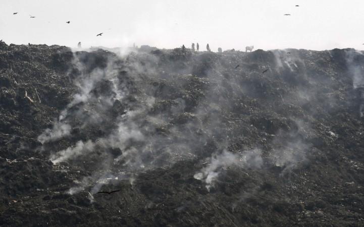 Landfill causes pollution and fires. (In file: Smoke emerges from a burning garbage dump at a landfill on the outskirts of New Delhi on October 13, 2017.) landfill