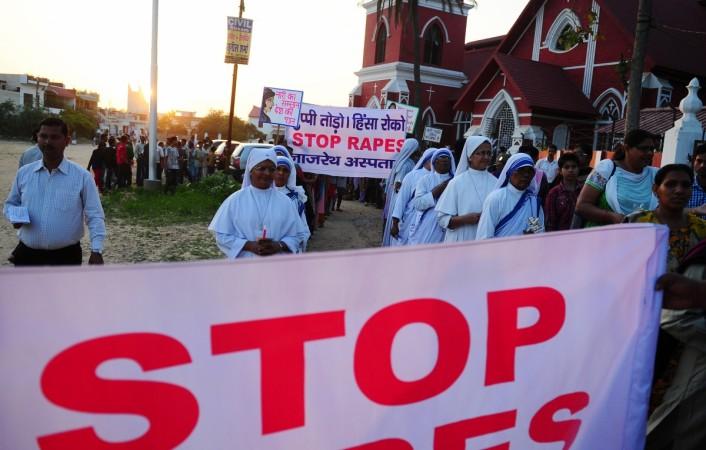 Indian Christians and social activists take part in a peace rally and protest in Allahabad on March 22, 2015 after the rape of a nun in West Bengal. The West Bengal state government, under pressure over the rape of an elderly nun, said it was handing over the case to the country's top investigators after coming under fire over the lack of arrests nuns protest against rape