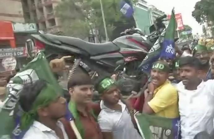 Loktantrik Janata Dal workers in Patna carry a motorbike on their shoulders to protest against fuel price hike bharat bandh protests