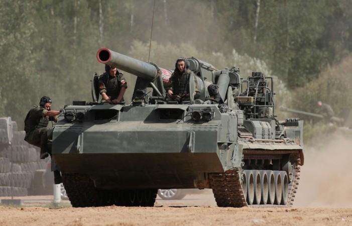 Russian servicemen sit atop a 2S5 Giatsint-S self-propelled howitzer during the annual international. Russia army