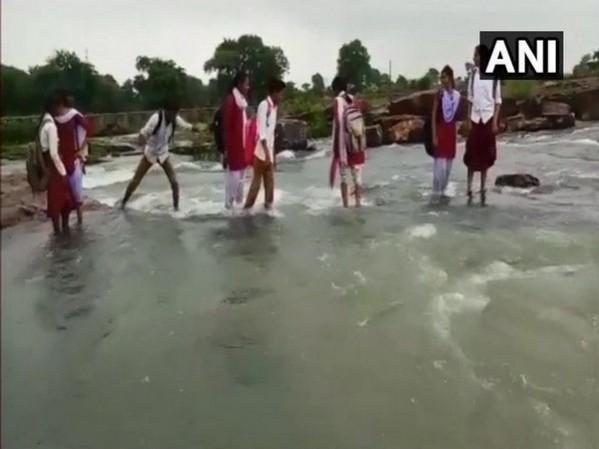 children crossing rivulet in MP brigde