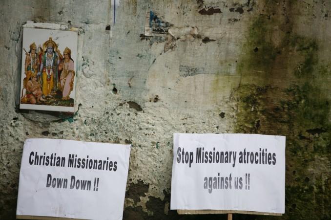 Placards are seen next to a photograph showing Hindu deities during a protest by Indian tribals against Christian missionaries in New Delhi September 6, 2011. The protesters are claiming the missionaries are Conversion to Christianity