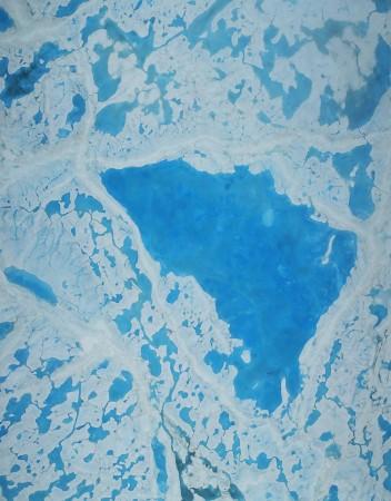 A large pond with melted water from the ice. melting ice