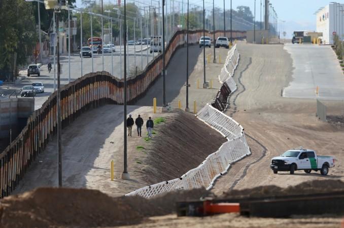 Three men from India jump the fence from Mexico and give themselves up to U.S. border patrol agents in Calexico, California,