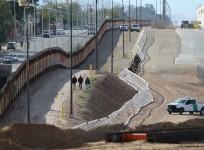 Three men from India jump the fence from Mexico and give themselves up to U.S. border patrol agents in Calexico, California,
